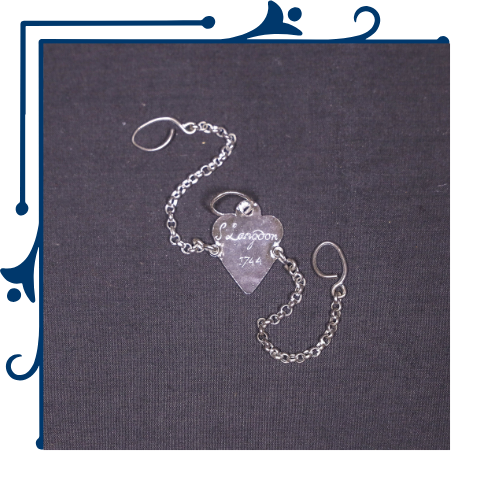 Adopt an Artifact: Silver pendant marked S. Langdon